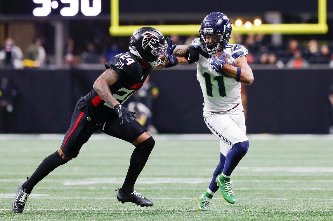 Jaxon Smith-Njigba (11) of the Seattle Seahawks catches a pass in front of A.J. Terrell (24) of the Atlanta Falcons during the first quarter at Mercedes-Benz Stadium on Dec, 7, 2025 in Atlanta.