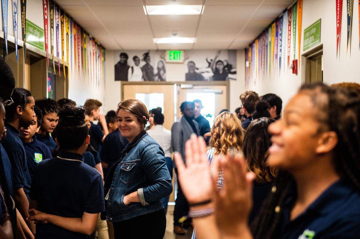 Students and faculty mingle and chat in a hallway before the start of a graduation ceremony at Destiny Charter Middle School in Tacoma on June 14, 2018.