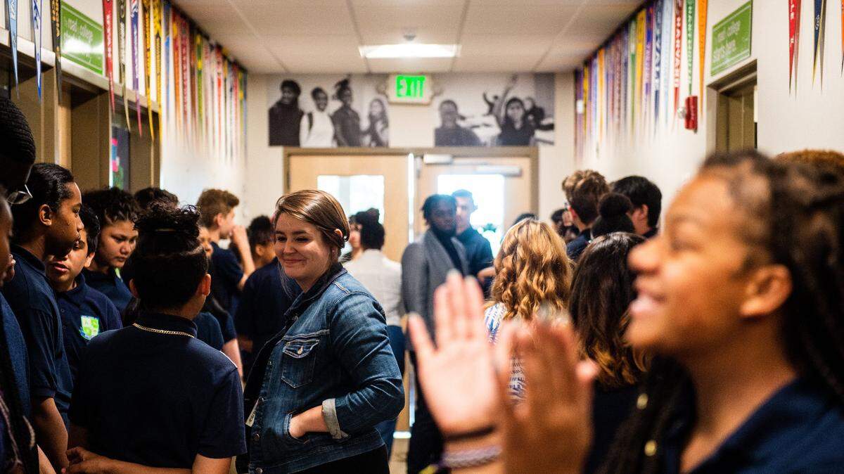 Students and faculty mingle and chat in a hallway before the start of a graduation ceremony at Destiny Charter Middle School in Tacoma on June 14, 2018.