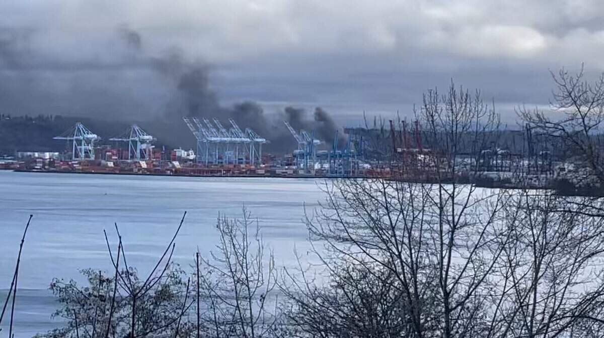 A plume of smoke rises from a fire burning inside an asphalt tank in the 2200 block os Taylor Way Saturday morning, Dec. 28, 2024.
