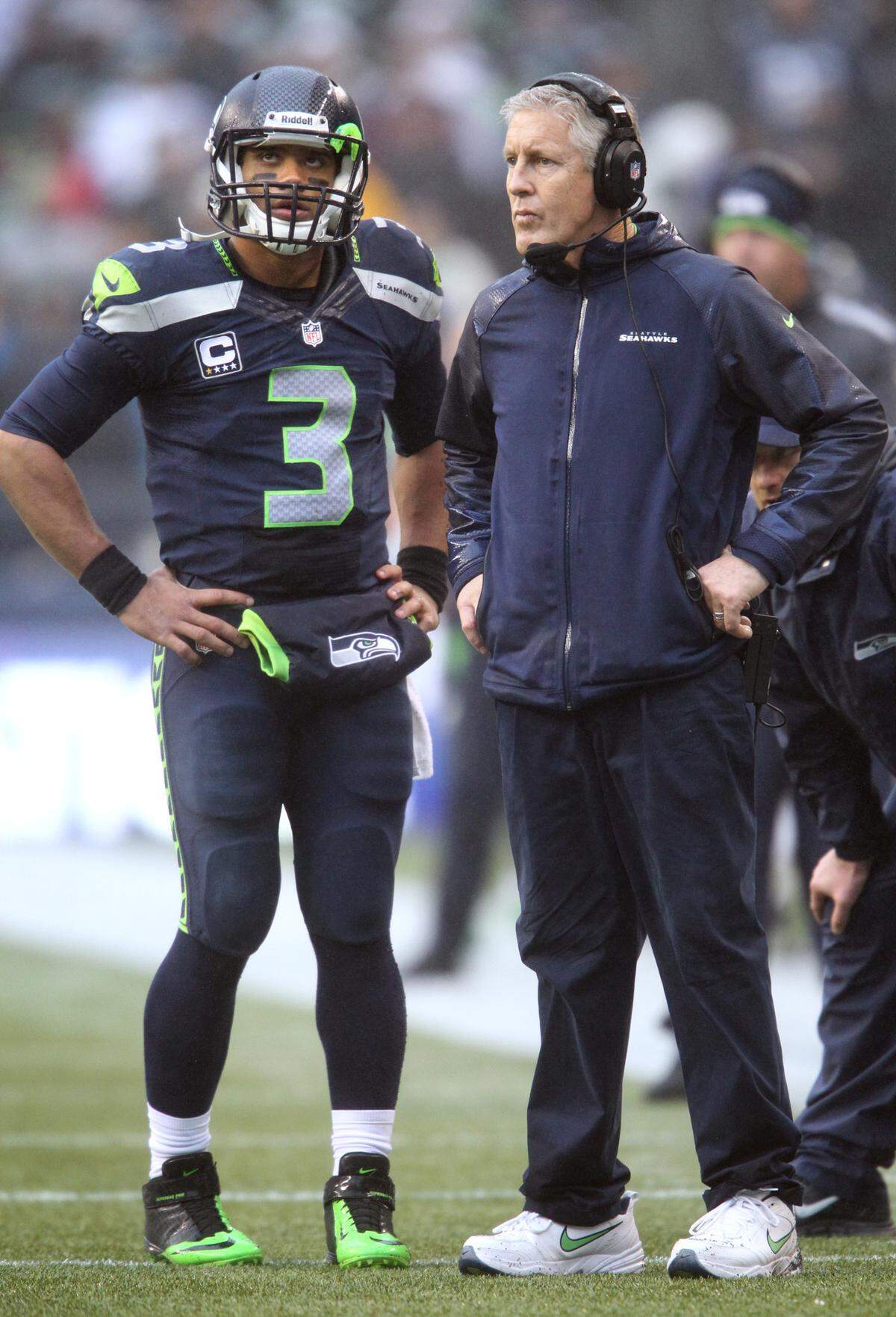 Seahawks quarterback Russell Wilson talks with head coach Pete Carroll during a timeout in the NFL football game against the Arizona Cardinals at CenturyLink Field in Seattle on Sunday, Dec. 22, 2013.