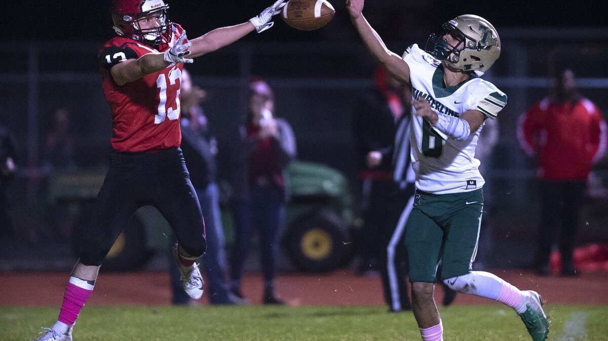 Timberline defensive back Izaiah Jerenz (6) tips the football, but Yelm wide receiver Kodee Gifford (13) makes a one-handed grab to open scoring with a 20-yard touchdown reception from quarterback Kyle Robinson during Friday night’s football game at Yelm High School on Oct. 26, 2018.