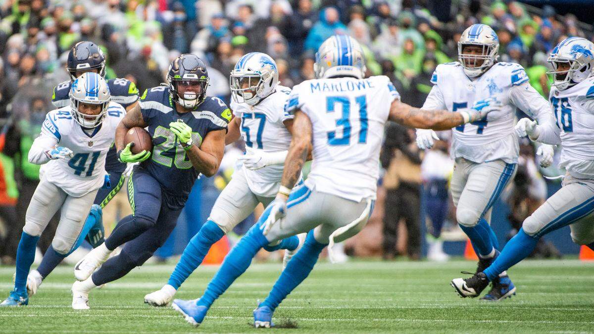 Seattle Seahawks running back Rashaad Penny (20) finds an opening the the Lions defense as he rushes upfield during the first quarter of an NFL game on Sunday, Jan. 2, 2022, at Lumen Field in Seattle.