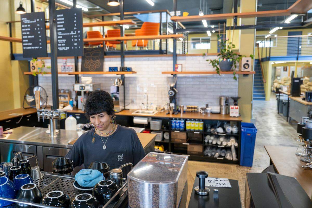 Barista Sarah Gomez works on a drink from behind the counter of Bluebeard Coffee Roasters on Thursday, June 5, 2025, in Tacoma. The coffee shop along South Tacoma Way is part of the South Tacoma neighborhood, where an ongoing planning effort endeavors to make the area more family-friendly, safe, and welcoming.