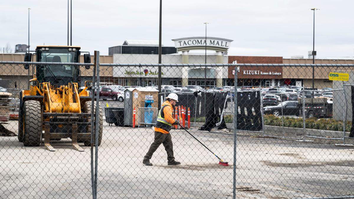 A construction crew works Feb. 17 at a site across from the Tacoma Mall where new food outlets will be opening. The former Pier 1 building is being remodeled as multiple storefronts.