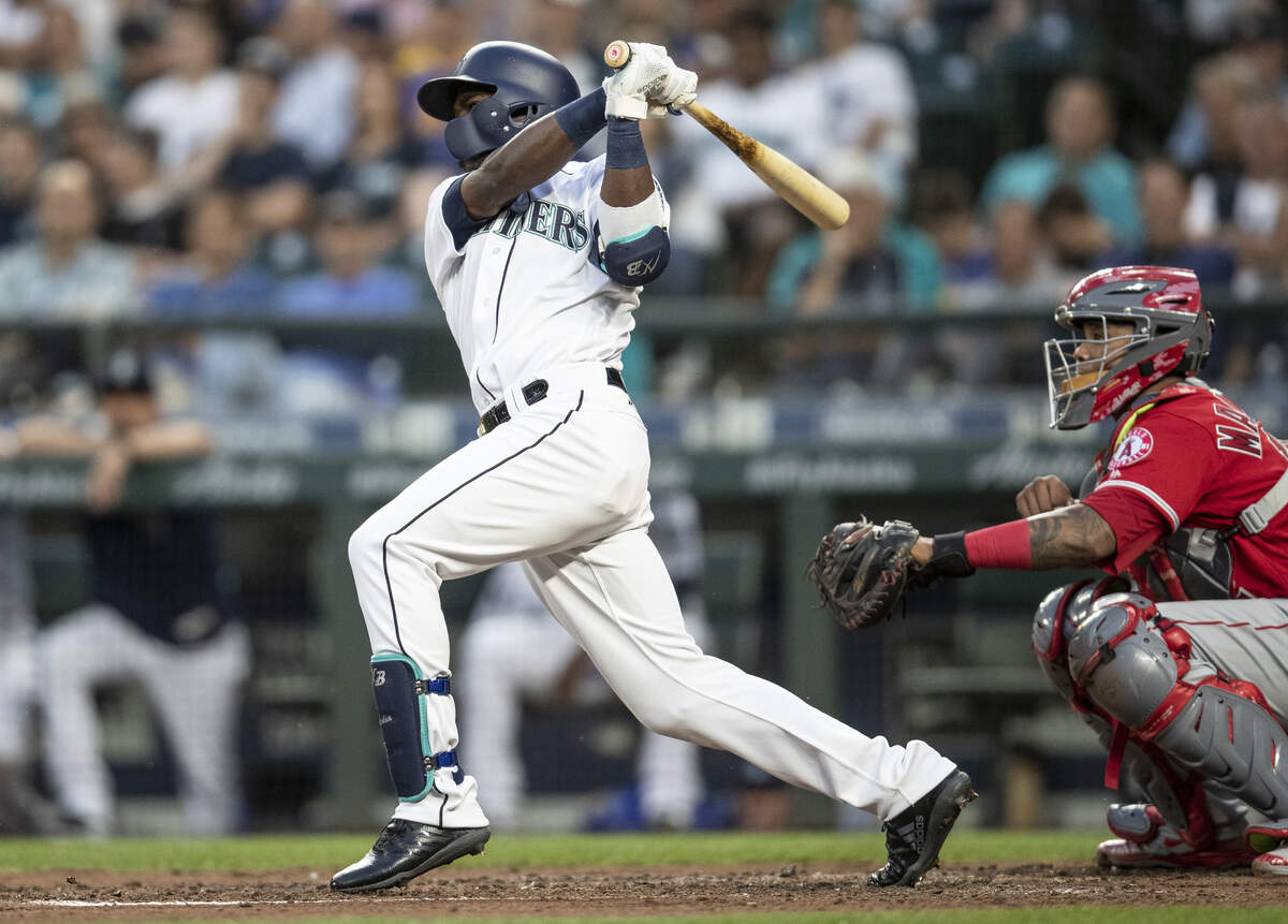 Seattle Mariners' Guillermo Heredia watches his RBI-double off of Los Angeles Angels starting pitcher Jaime Barria during the fifth inning of a baseball game Thursday, July 5, 2018, in Seattle. (AP Photo/Stephen Brashear)