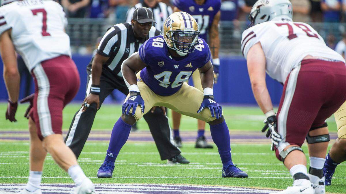 UW linebacker Edefuan Ulofoshio lines up near the line of scrimmage. The Washington Huskies played the Montana Grizzlies at Husky Stadium in Seattle on Saturday, Sept. 4, 2021.
