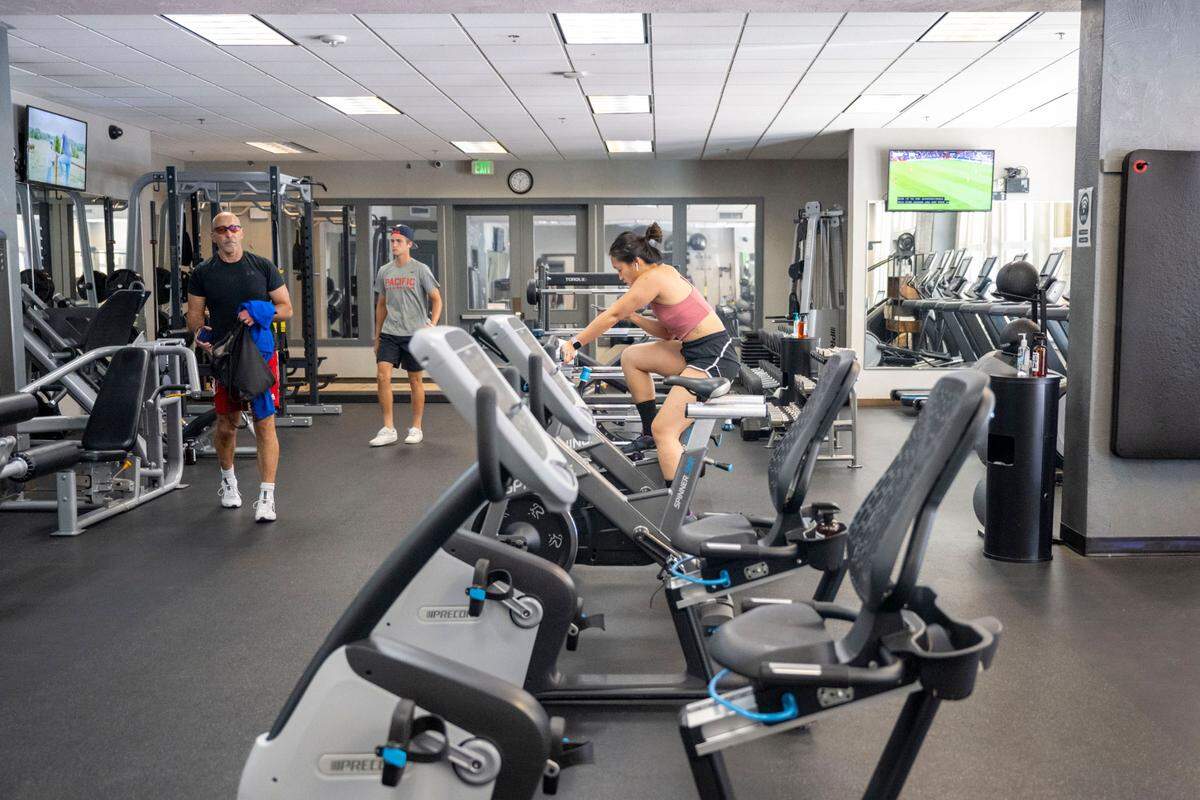 People work out in the fitness center at Grit City Wellness on Friday, July 22, 2022, in Tacoma, Wash.