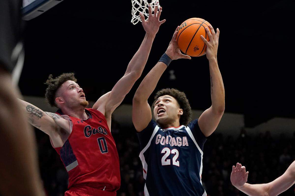 Gonzaga forward Anton Watson (22) shoots against Saint Mary’s guard Logan Johnson (0) during the first half of an NCAA college basketball game in Moraga, Calif., Saturday, Feb. 26, 2022. (AP Photo/Jeff Chiu)