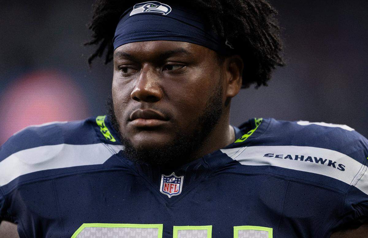 Seattle Seahawks guard Christian Haynes (64) watches from the sidelines during the first quarter of the preseason game against the Cleveland Browns at Lumen Field, on Saturday, Aug. 24, 2024 in Seattle, Wash.