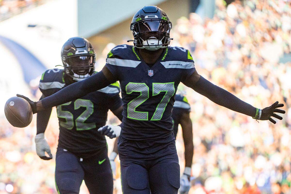 Seattle Seahawks cornerback Tariq Woolen (27) celebrates after recovering a fumble by Arizona Cardinals quarterback Kyler Murray (1) during the third quarter of an NFL game on Sunday, Oct. 16, 2022, at Lumen Field in Seattle.