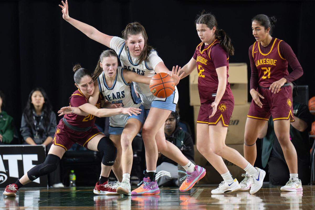 Lakeside guard Willa Chinn (20), Central Valley forward Aspen Henry (13) and forward Brynn McGaughy (42) attempt to grab a loose ball during the third quarter of the Class 3A state championship game at the Tacoma Dome on Saturday, March 8, 2025, in Tacoma, Wash.