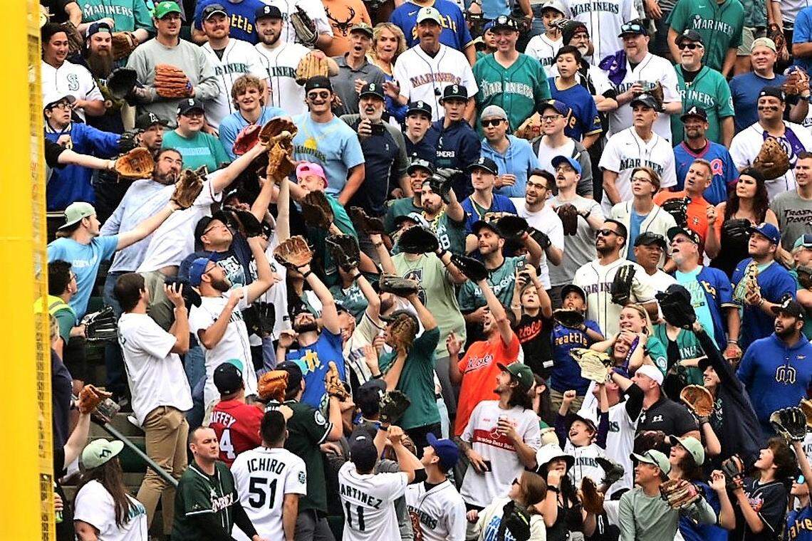 Fans try to grab a home run ball at the 2023 MLB Home Run Derby at T-Mobile Park in Seattle on Monday, July 10, 2023.