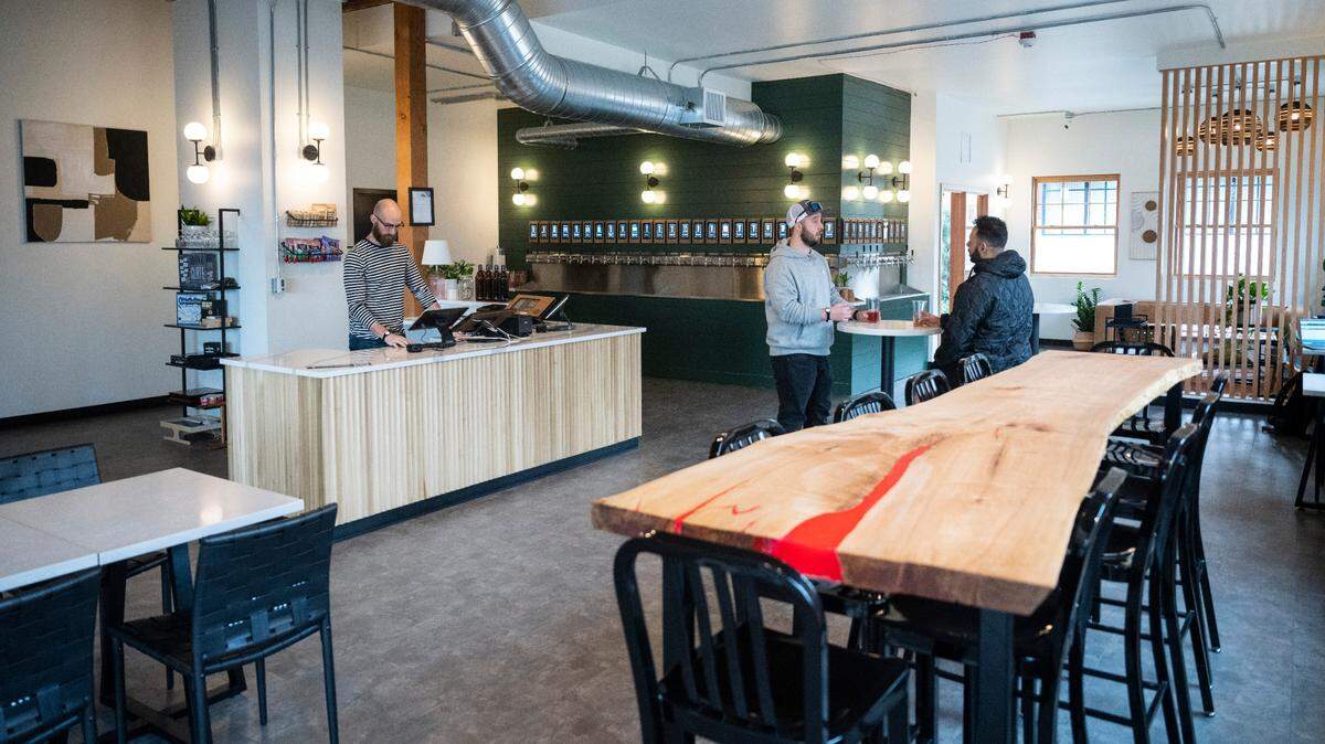 Customers enjoy beers at The Living Taproom, a new self-serve beer bar in downtown Tacoma, Wash. on Jan. 30, 2023.