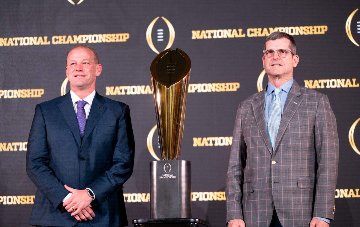 Washington head coach Kalen DeBoer and Michigan head coach Jim Harbaugh pose for photos ahead of the College Football Playoff National Championship game, on Sunday, Jan. 7, 2024, in Houston.