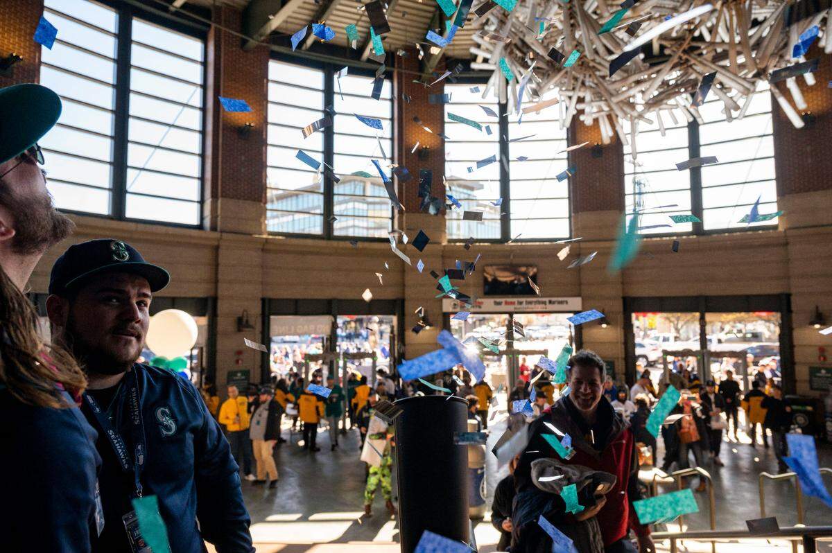 Confetti flies into the air as fans enter at the home plate entrance of T-Mobile Park prior to the start of the Mariners home opener in Seattle on Friday, April 15, 2022.