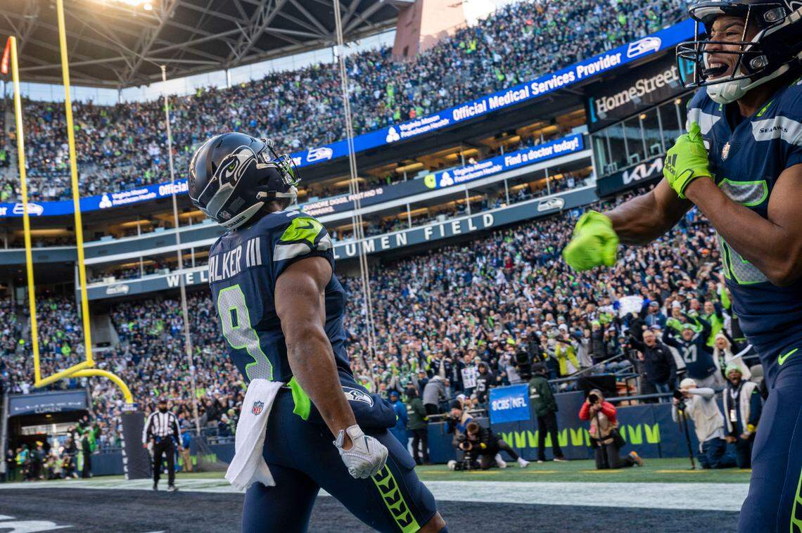 Seattle Seahawks running back Kenneth Walker III (9) and wide receiver Tyler Lockett (16) celebrate after Walker III’s touchdown in the first quarter of an NFL game on Sunday, Nov. 27, 2022, at Lumen Field in Seattle.