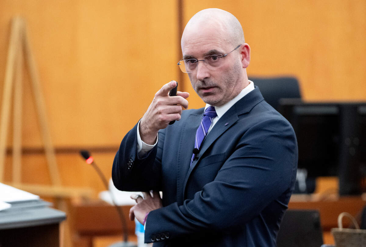 Defense attorney Jared Ausserer gestures to the sister and mother of Manny Ellis in the gallery while giving closing arguments for defendant Matthew Collins during the trial of three Tacoma Police officers in the killing of Manny Ellis at Pierce County Superior Court, Tuesday, Dec. 12, 2023, in Tacoma, Wash. Tacoma Police Officers Christopher Burbank, Matthew Collins and Timothy Rankine stand trial for charges related to the March 2020 killing of Manny Ellis. (Brian Hayes / Pool Photo – The News Tribune)