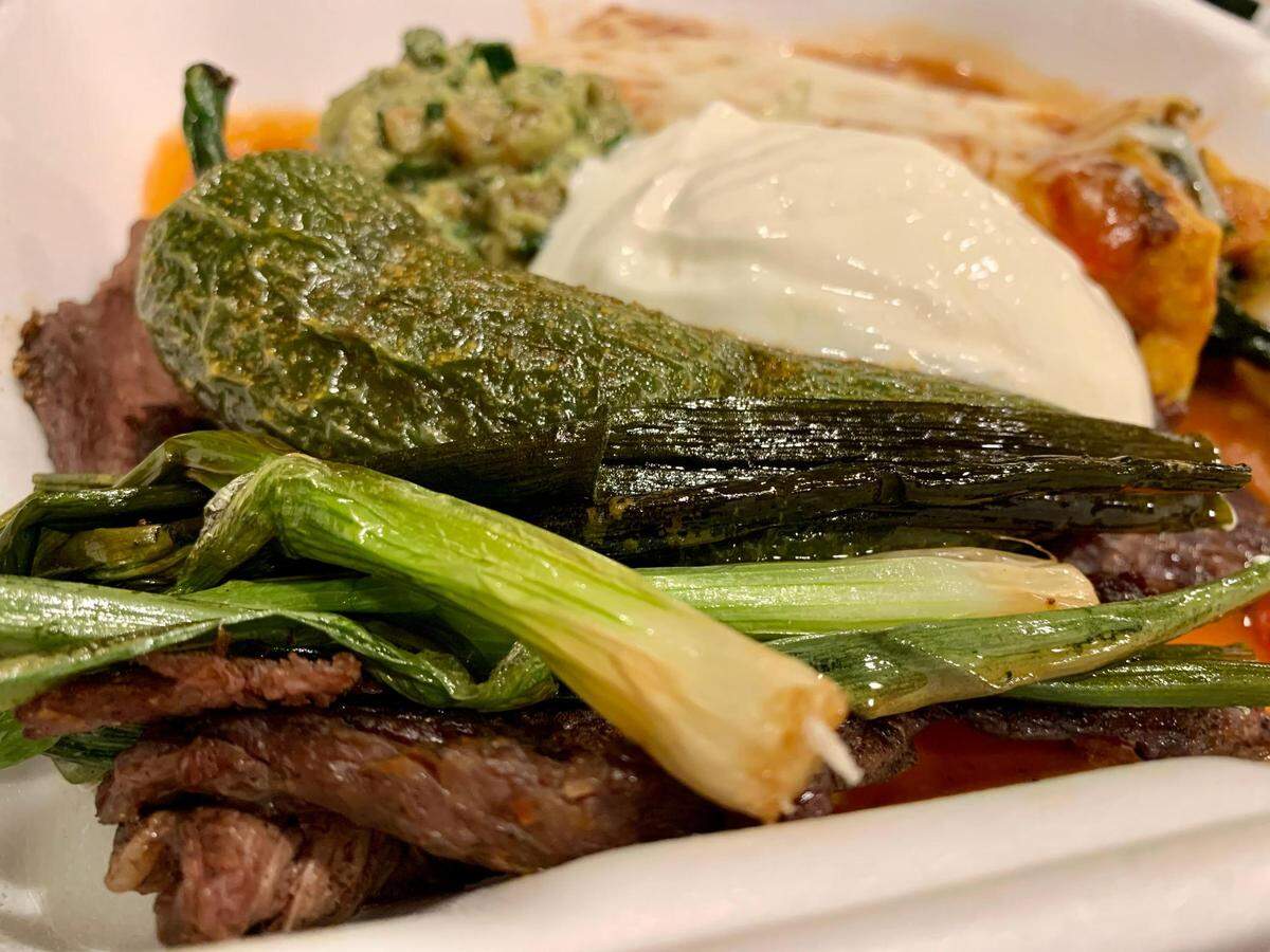 One of several house specialties from the Mexican state of Guerrero, these enchiladas costenas could feed a family, replete with steak, guacamole, grilled jalapenos and cebollitas.