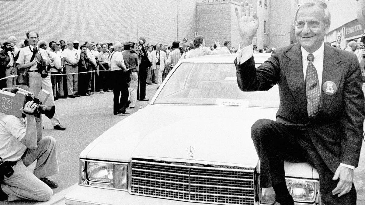 In this Aug. 6, 1980, file photo, Chrysler Corp. Chairman Lee Iacocca sits on the hood of K Car Number One, a Plymouth Reliant, in Detroit. Former Chrysler CEO Iacocca, who became a folk hero for rescuing the company in the ’80s, has died, former colleagues said Tuesday, July 2, 2019. He was 94.