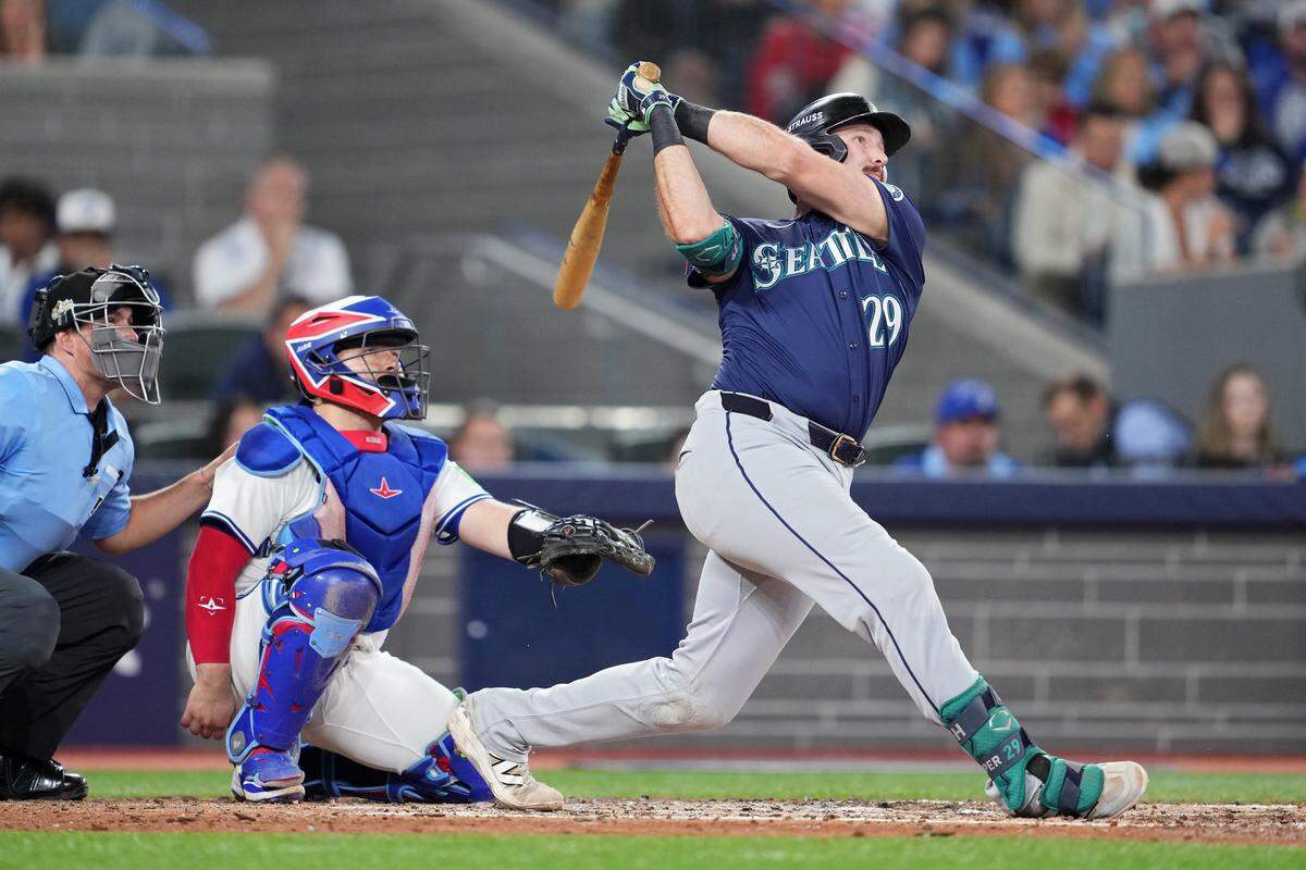 TORONTO, ONTARIO - OCTOBER 20: Cal Raleigh #29 of the Seattle Mariners hits a solo home run during the fifth inning against the Toronto Blue Jays in game seven of the American League Championship Series at the Rogers Centre on October 20, 2025 in Toronto, Ontario. (Photo by Mark Blinch/Getty Images)