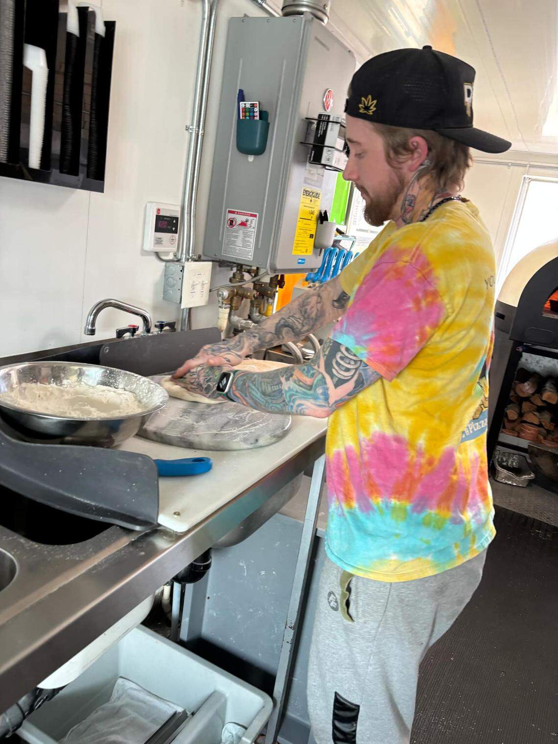 Samuel Ranz makes pizzas inside one of the couple’s two food trucks outside the Gordon Family YMCA on April 9.