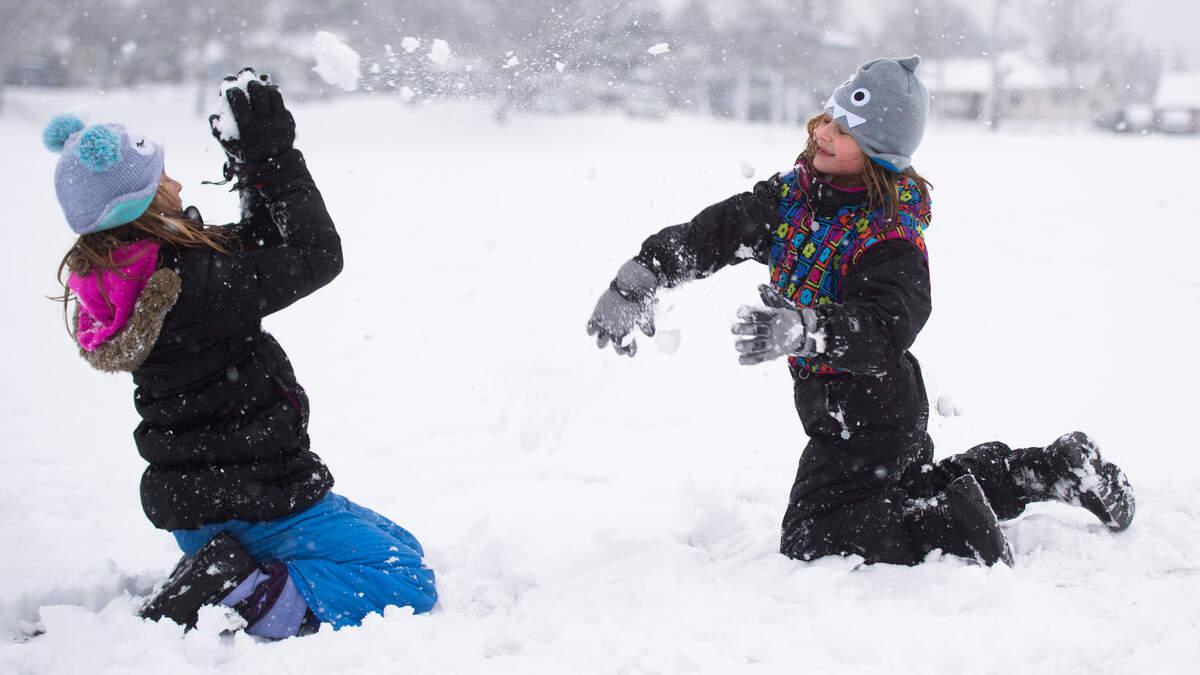 Lucy McElligott, left, and Polly McElligott, right, play in the snow at Vassault Park in Tacoma on Feb. 8, 2019.