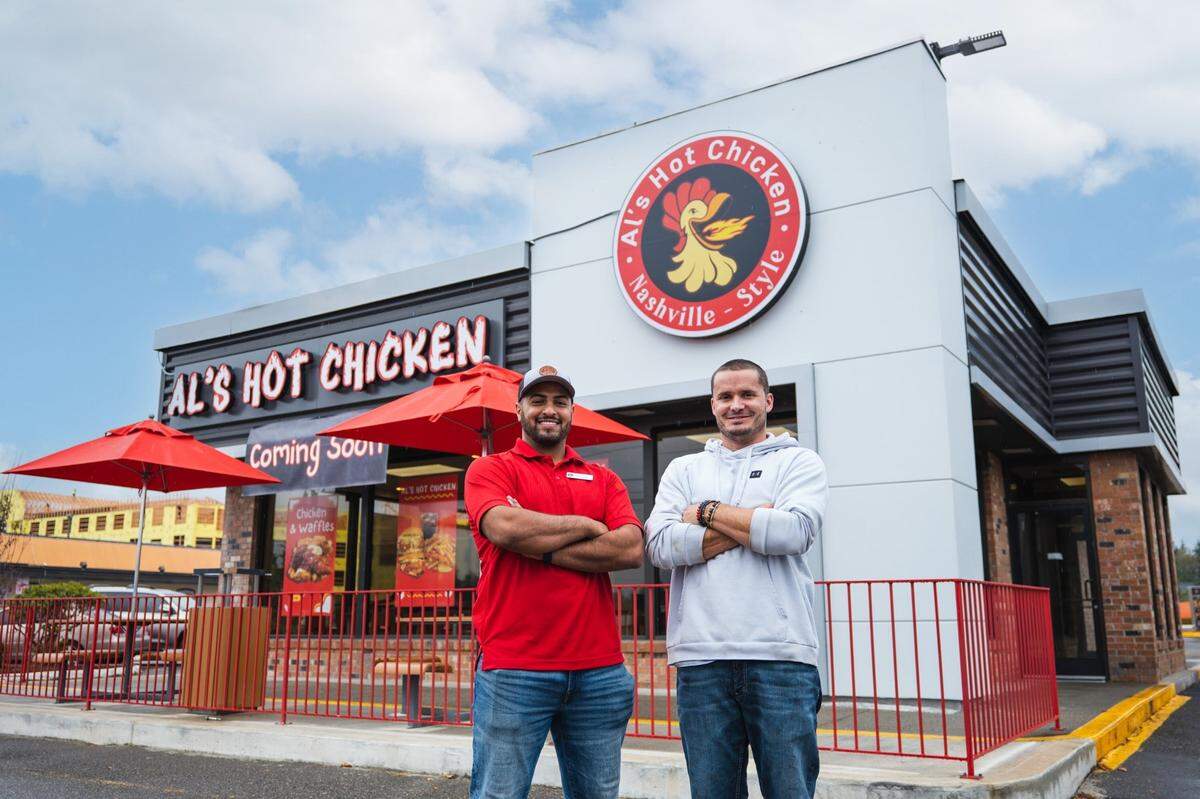 Al’s Hot Chicken franchise co-owners Burhan Saleh (left) and Kasey Gano (right) outside their new restaurant at 2102 Mildred St. in University Place, Wash.