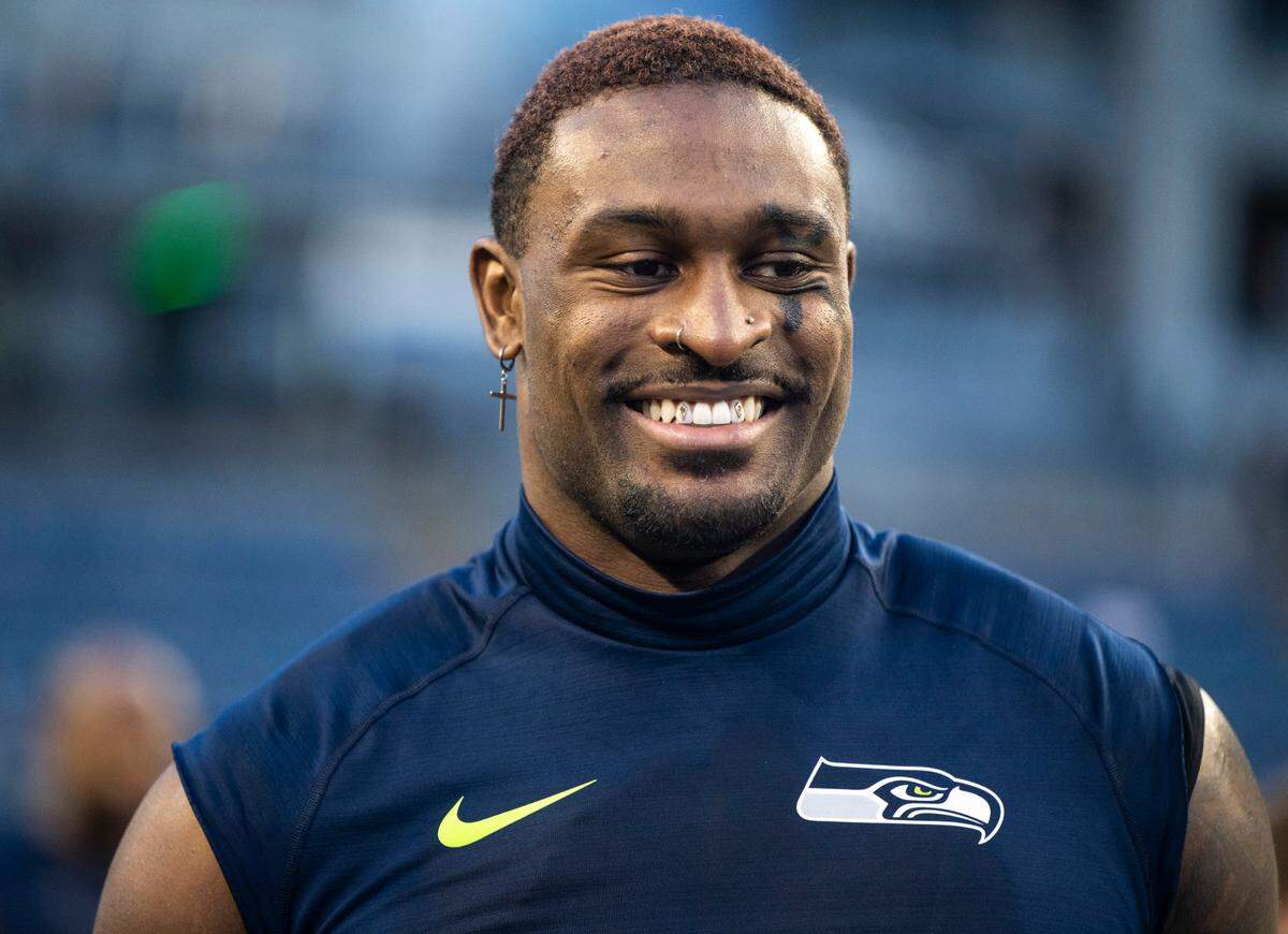 Seattle Seahawks wide receiver DK Metcalf (14) smiles while talking to New York Jets players on the field after an NFL game at Lumen Field in Seattle Wash. on Jan. 1, 2023. The Seahawks defeated the Jets 23-6.