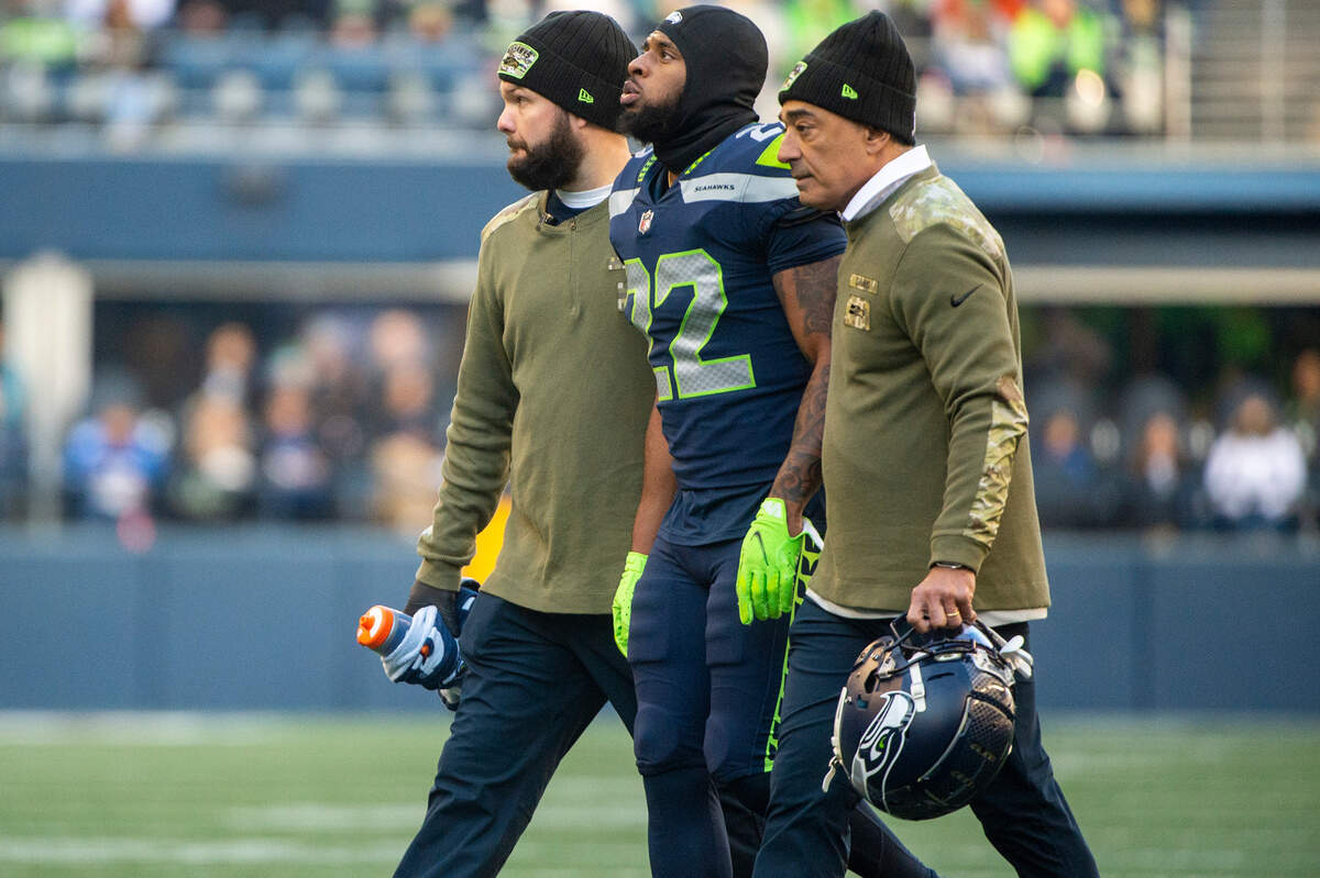 Seattle Seahawks cornerback Tre Brown (22) is helped off of the field after injuring his knee on a play in the second quarter of an NFL game against the Arizona Cardinals on Sunday afternoon at Lumen Field in Seattle.