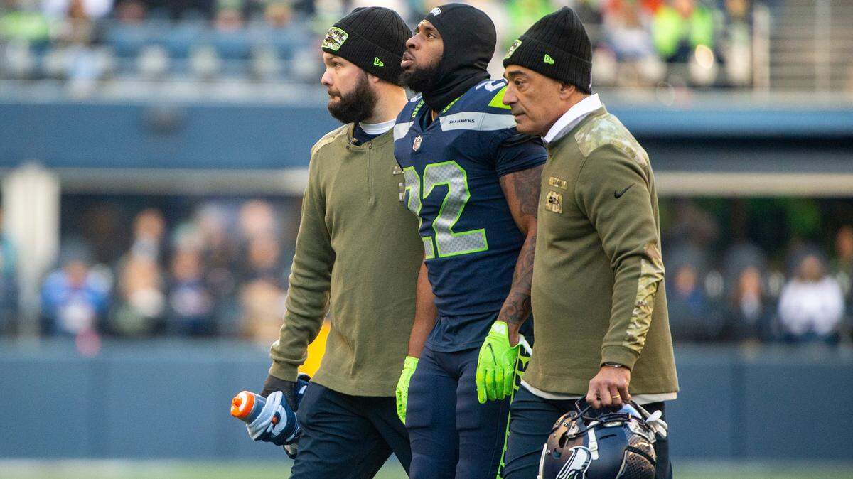 Seattle Seahawks cornerback Tre Brown (22) is helped off of the field after injuring his knee on a play in the second quarter of an NFL game against the Arizona Cardinals on Sunday afternoon at Lumen Field in Seattle.