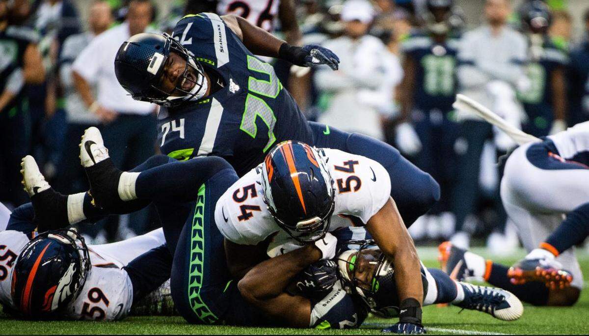 Seahawks offensive tackle George Fant reacts in pain after getting his ankle rolled up on during the preseason opener against Denver on Aug. 8 at CenturyLink Field. Fant got a second-degree sprained ankle on the play.