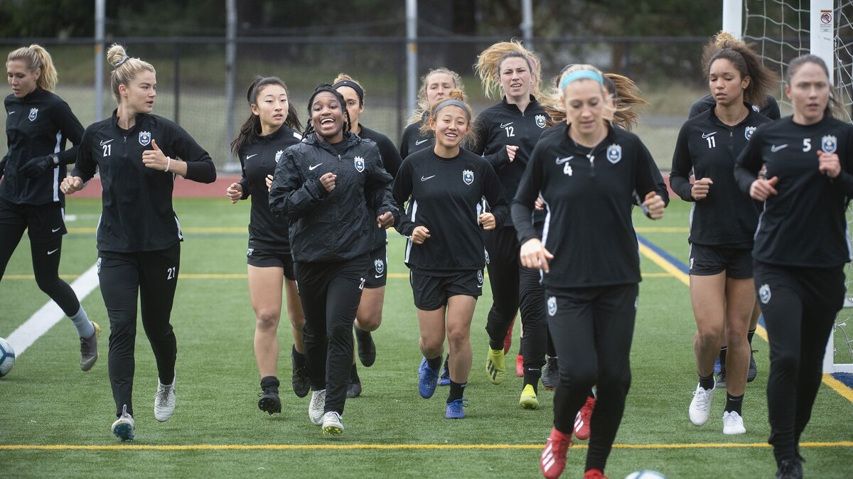 Reign FC players hit the pitch for warm-ups during soccer practice at Foss High School in Tacoma on Tuesday, April 9, 2019.