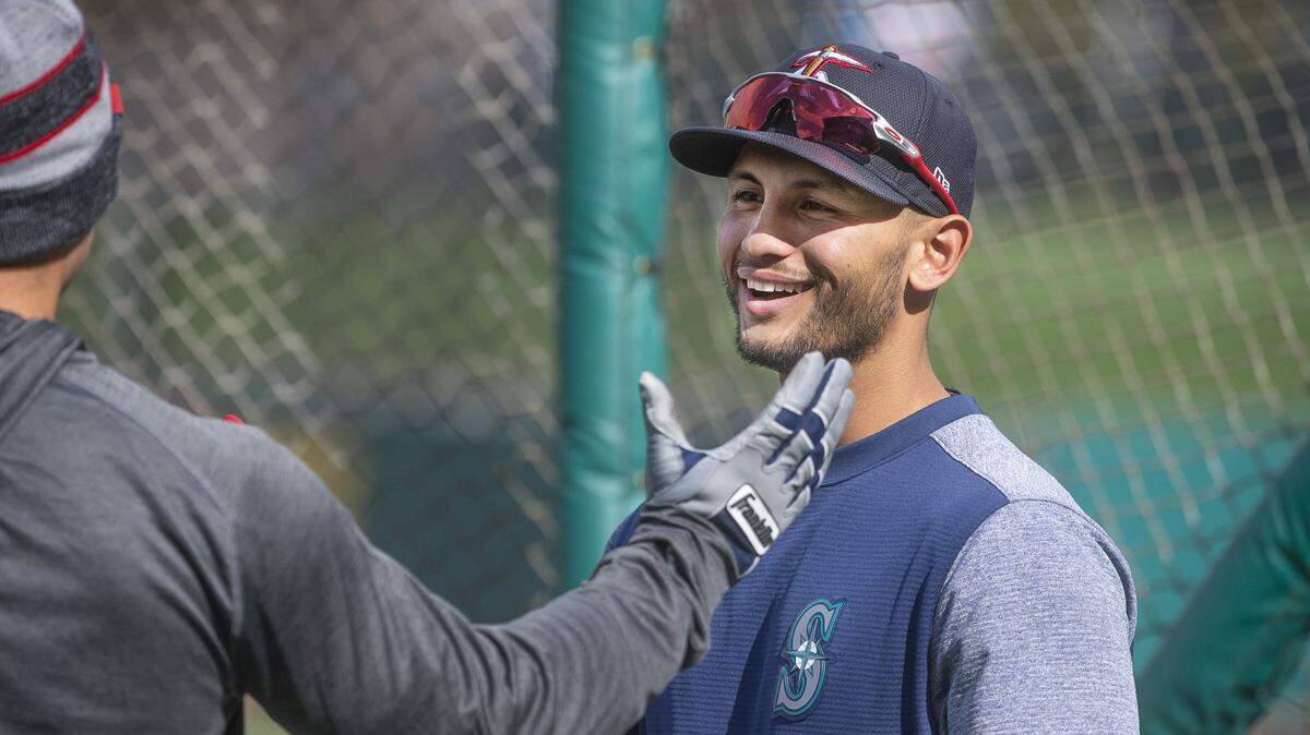 Tacoma Rainiers second baseman Tim Lopes greets an El Paso Chihuahua’s player as they warm up before the Tacoma Rainiers’ home opener at Cheney Stadium in Tacoma on Tuesday, April 9, 2019.