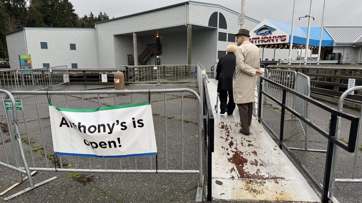 A couple use a gangway to access Anthony’s and Point Defiance Friday afternoon, bypassing an unstable sidewalk. Dec. 27, 2024.