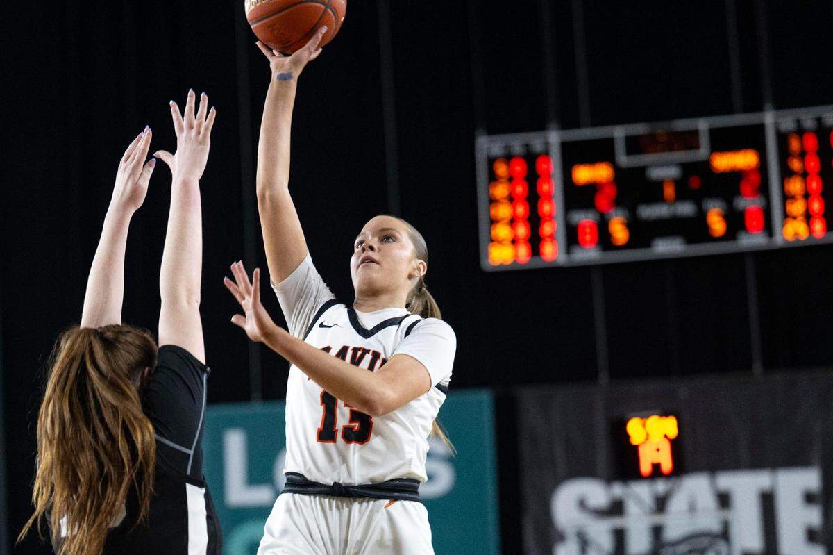 Davis guard Cheyenne Hull (13) attempts a shot over Sumner forward Parker Gould (25) during the first quarter of the Class 4A state championship game at the Tacoma Dome on Saturday, March 8, 2025, in Tacoma, Wash.