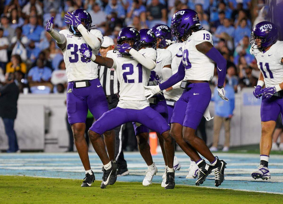 CHAPEL HILL, NORTH CAROLINA - SEPTEMBER 01: Safety Bud Clark #21 and members of the Texas Christian University Horned Frogs celebrate after Clarks interception returned for a touchdown at the end of the first half against the University of North Carolina Tar Heels at Kenan Stadium on September 01, 2025 in Chapel Hill, North Carolina. (Photo by Alex Halloway/Getty Images)