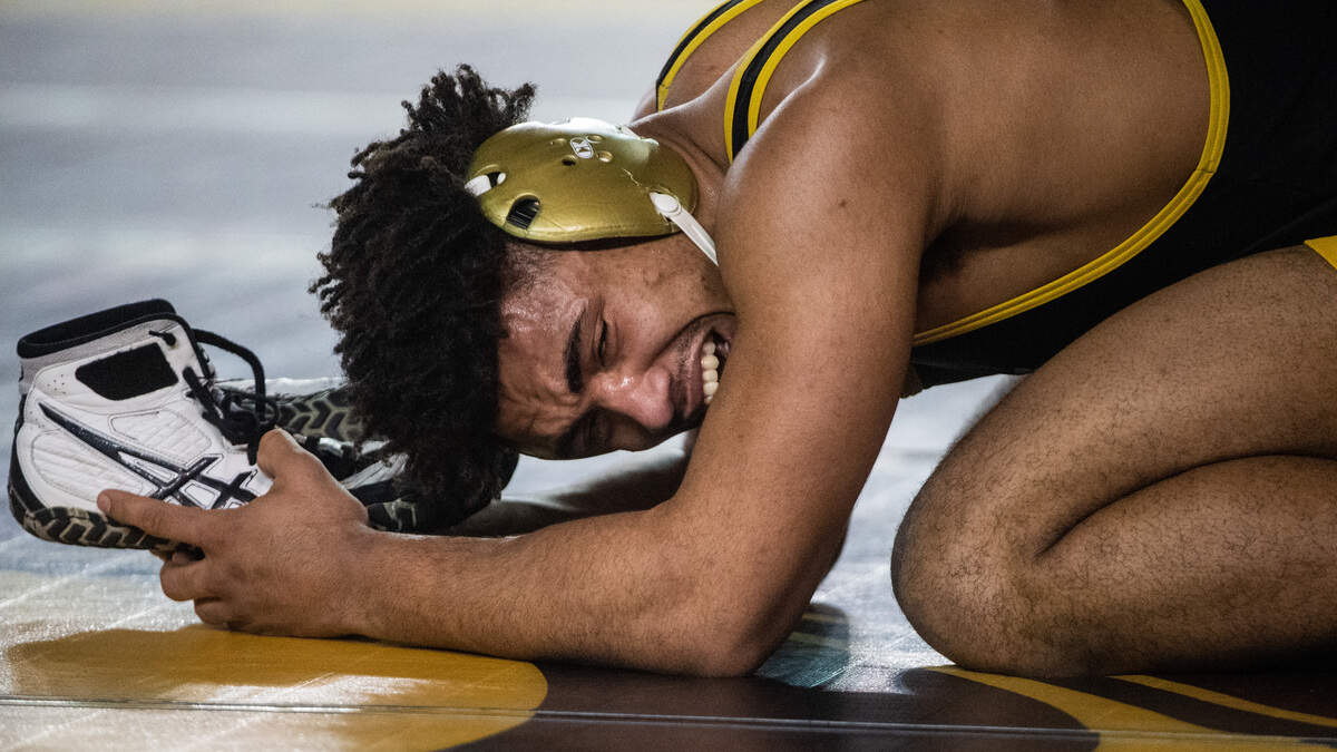 Tahoma’s Michael Gasper is overcome with emotion as he retires a pair of wrestling shoes that belonged to former teammate Kione Gill, a Tahoma wrestler who died of suicide in 2018. Gasper competed in the 4A 195-pound championship during day two of Mat Classic XXXII at the Tacoma Dome in Tacoma, Wash., on Saturday, Feb. 22, 2020.