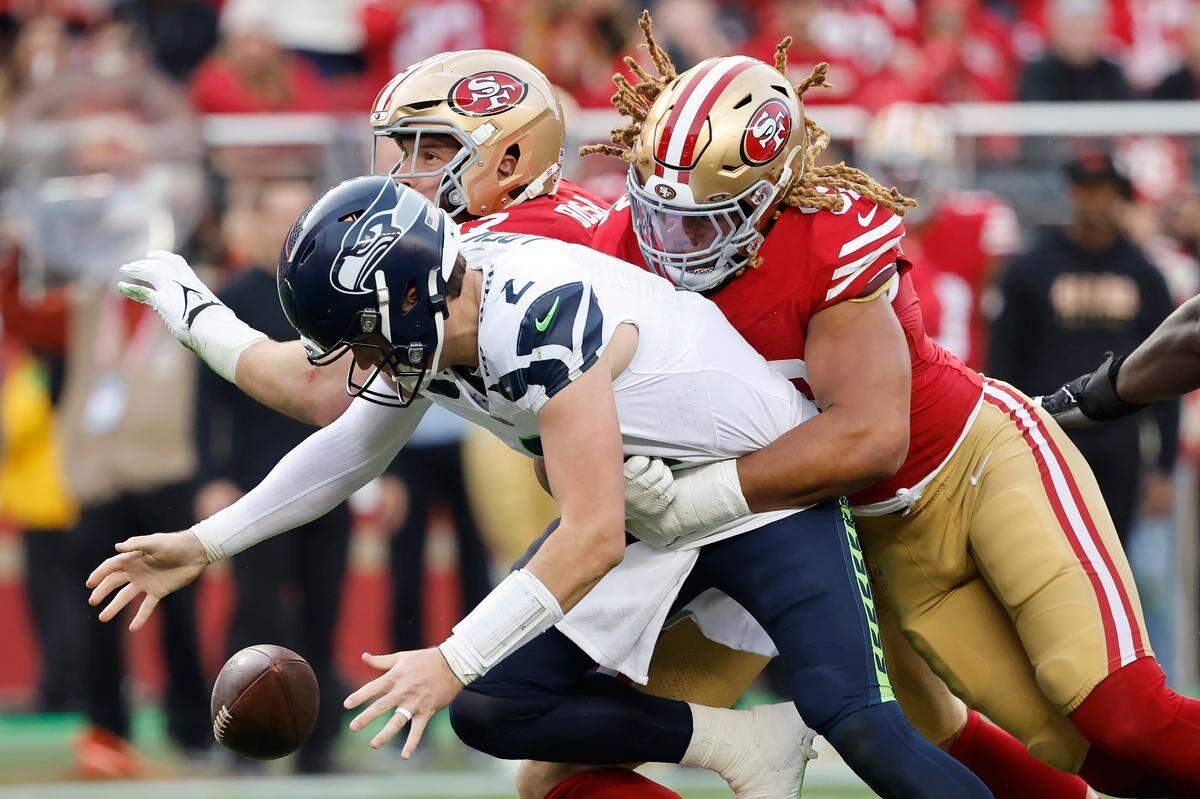 Seattle Seahawks quarterback Drew Lock, foreground, reaches for the ball in front of San Francisco 49ers defensive end Chase Young, right, and defensive end Nick Bosa on a failed two point conversion attempt during the second half of an NFL football game in Santa Clara, Calif., Sunday, Dec. 10, 2023. (AP Photo/Josie Lepe)