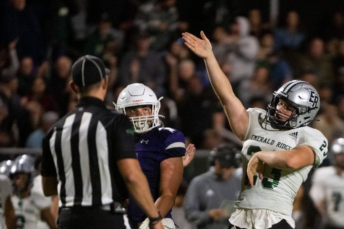 Emerald Ridge running back Logan Lisherness signals first down after gaining enough yards on the ground to move the chains and essentially clinch a win for the Jaguars over Sumner in a 4A SPSL game on Friday, Sept. 16, 2022, at Sunset Chev Stadium in Sumner, Wash.