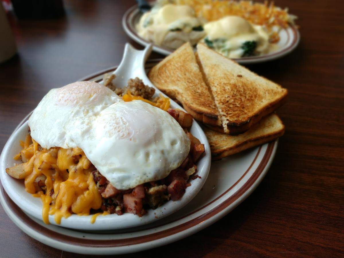 A meat lovers stacker, front, and eggs Benedict, rear, from Tim’s Kitchen in Puyallup.