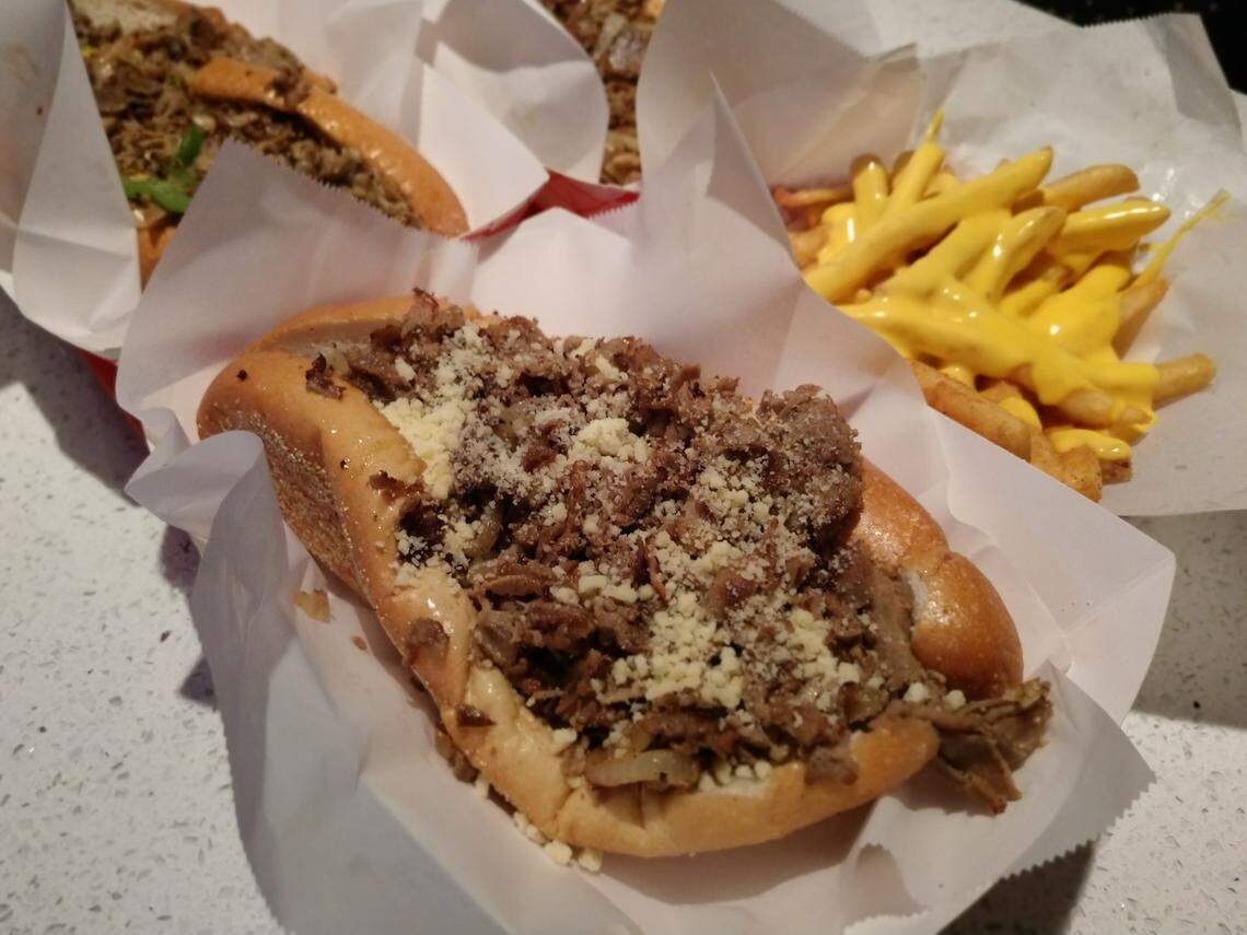 The Atomic Garlic Parm cheesesteak (front), the Atomic Fries (rear right) and the South Philly from Straight from Philly in downtown Tacoma.