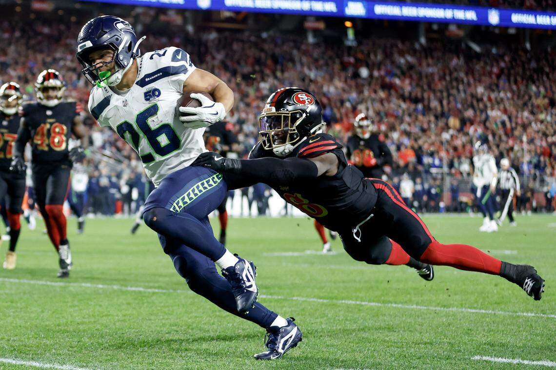 SANTA CLARA, CALIFORNIA - JANUARY 03: Zach Charbonnet #26 of the Seattle Seahawks scores a touchdown against Malik Mustapha #6 of the San Francisco 49ers during the first quarter of a game at Levi's Stadium on January 03, 2026 in Santa Clara, California. (Photo by Lachlan Cunningham/Getty Images)