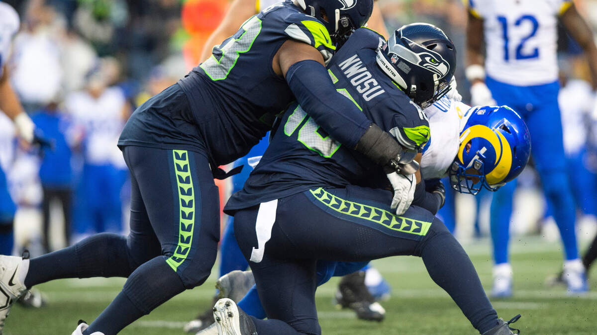Seattle Seahawks linebacker Uchenna Nwosu (10) sacks Los Angeles Rams quarterback Baker Mayfield (17) in overtime of an NFL game at Lumen Field in Seattle, Wash. on Jan. 8, 2023. The Seahawks defeated the Rams in overtime 19-16.