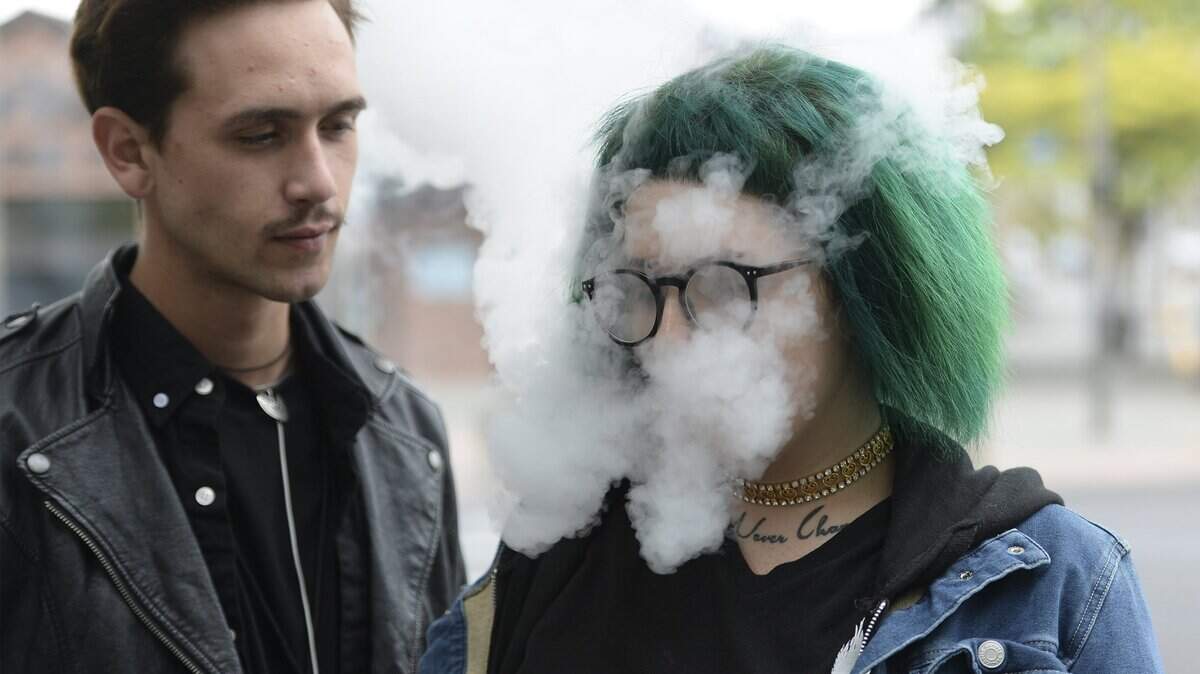 Cooper Lariviere, left, takes a break with his friend Bre Christy, who was vaping in downtown Bellingham in August 2016.