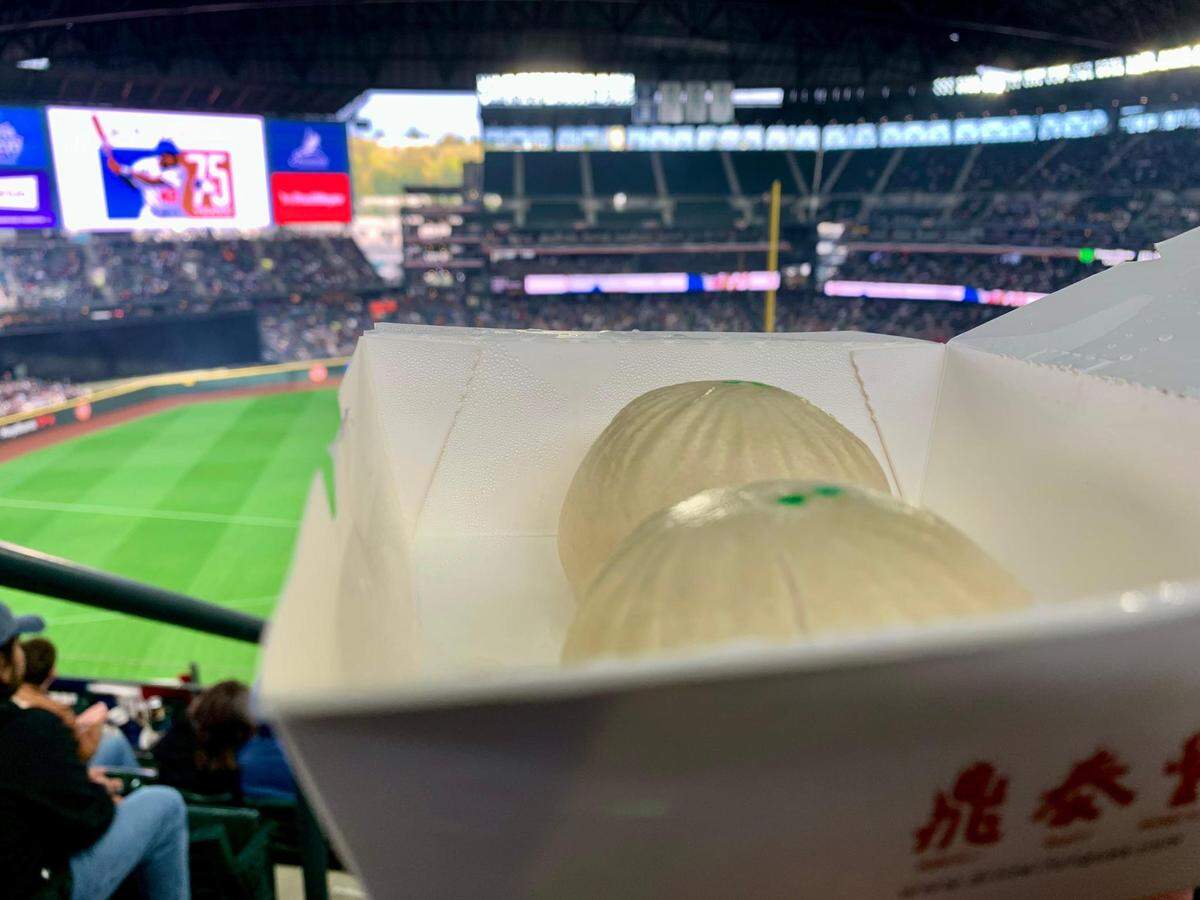 Din Tai Fung, located behind Section 132 at T-Mobile Park, offers pork or veggie buns, spicy wontons and chicken fried rice, tossed to order in a wok visible as you wait in line. It took about 20 minutes to reach the cashier here on Saturday, April 16, 2022, as the Seattle Mariners lost to the Houston Astros in their second game of the season.