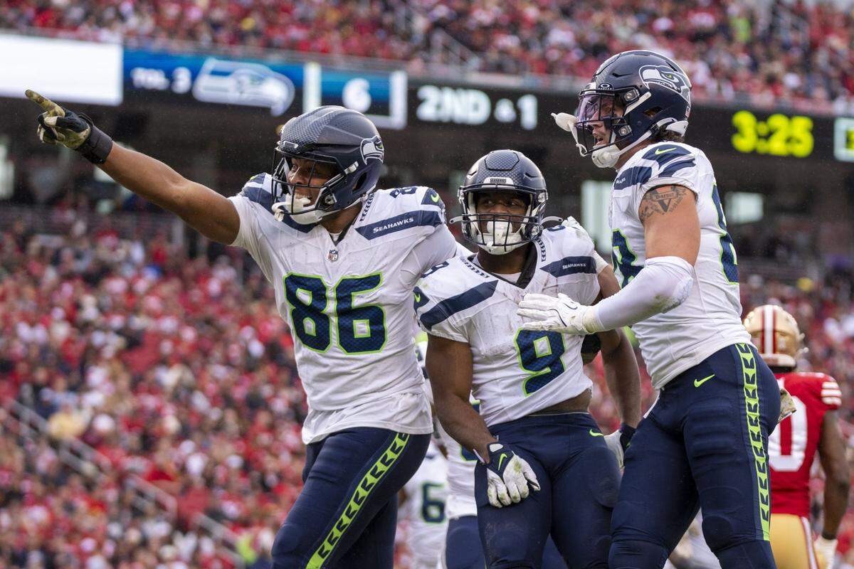 November 17, 2024; Santa Clara, California, USA; Seattle Seahawks running back Kenneth Walker III (9) is congratulated by tight end Pharaoh Brown (86) and tight end AJ Barner (88) for scoring a touchdown against the San Francisco 49ers during the third quarter at Levi's Stadium. Mandatory Credit: Kyle Terada-Imagn Images