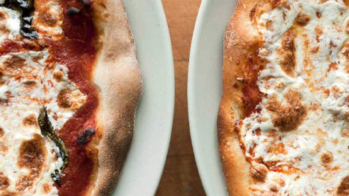 Pictured here are two pizza pies.
