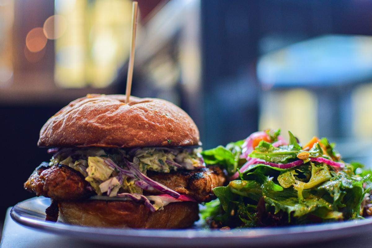 A blackened chicken sandwich is one of several lunch-y items on the menu, which also includes vegan and veg-friendly options.