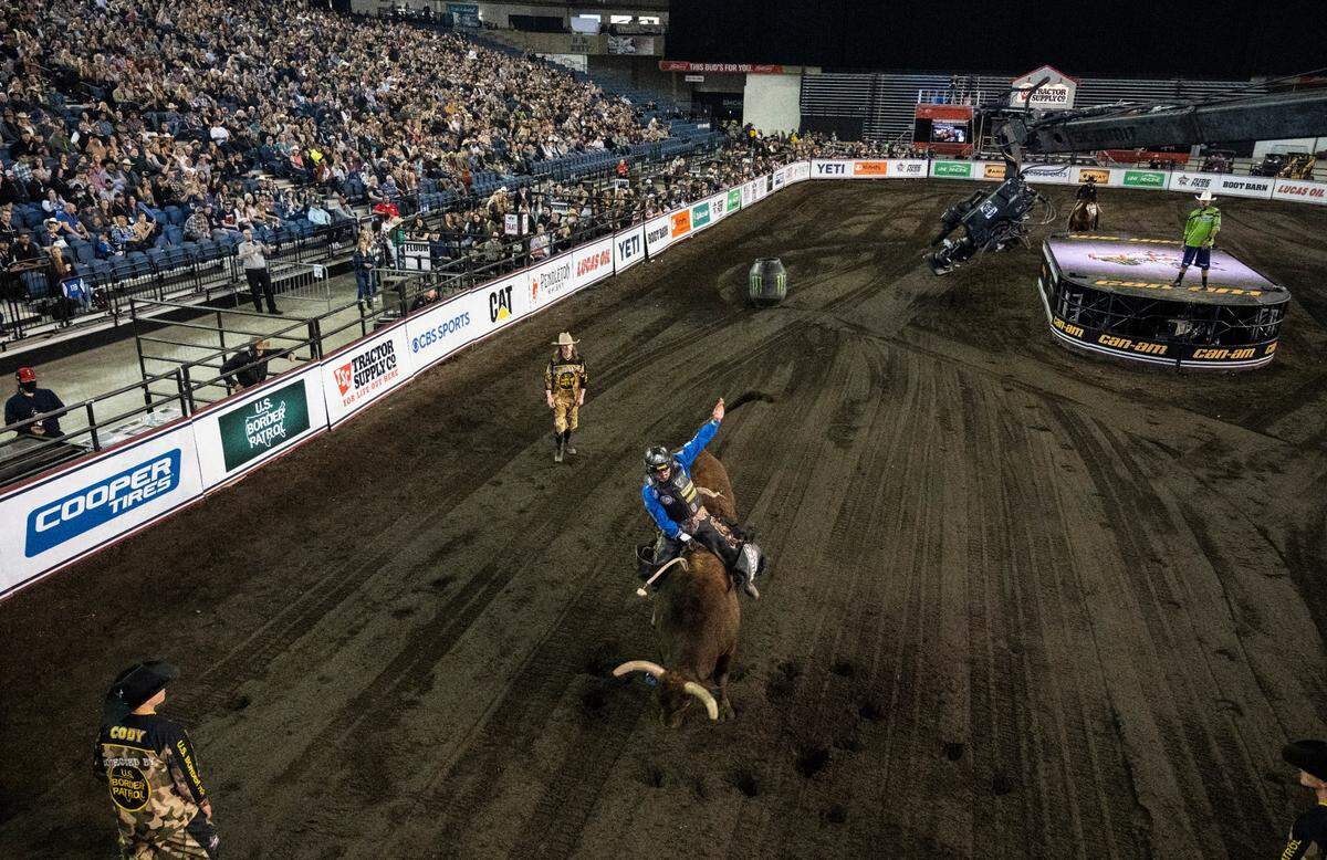 A bull rider competes in the 2022 Professional Bull Riders Unleash the Beast Tour in the Tacoma Dome in Tacoma, Wash. on Saturday, April 9, 2022.